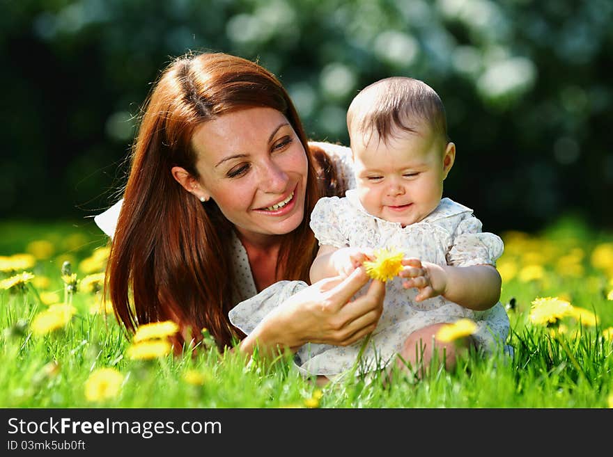 Mother and daughter on the green grass