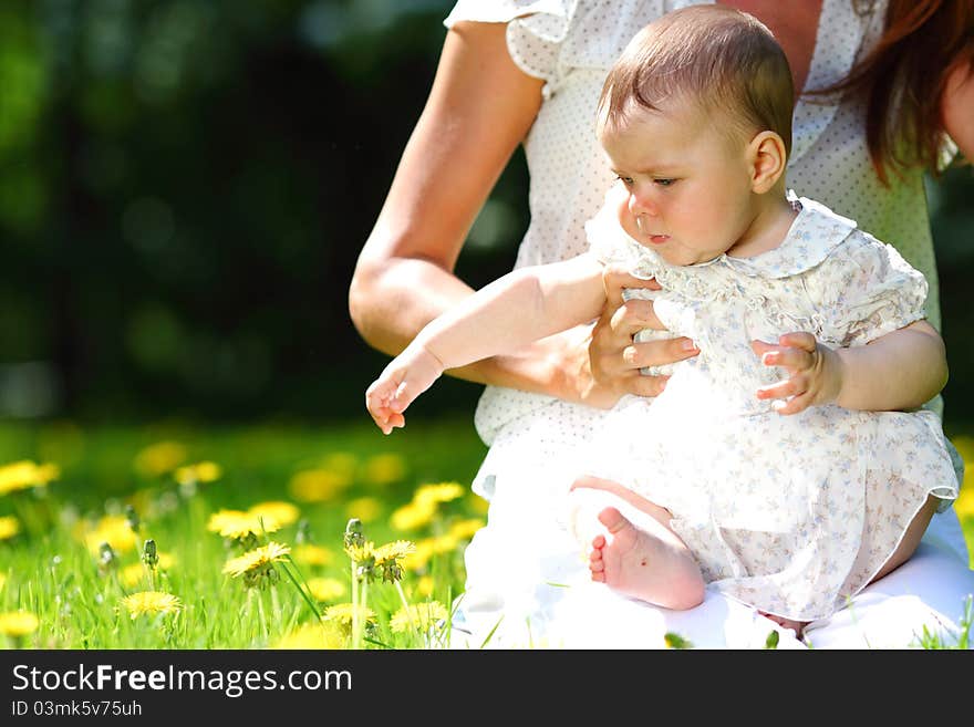 Mother and daughter on the green grass