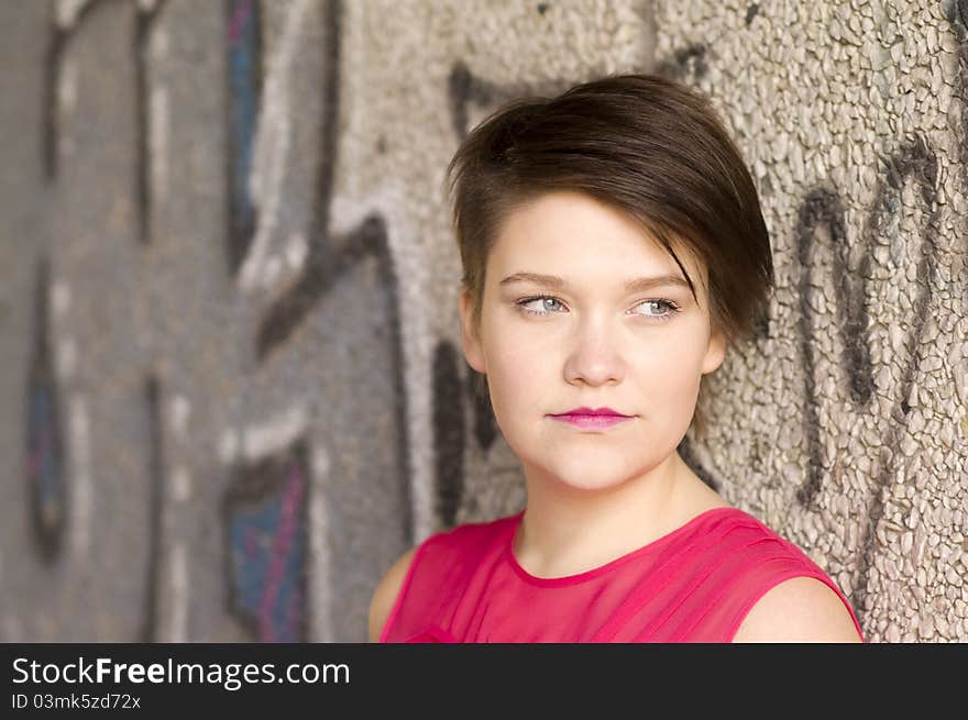 Young Woman Next To Graffiti Wall