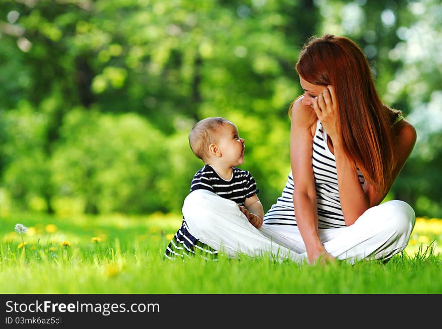 Mother and daughter on the green grass