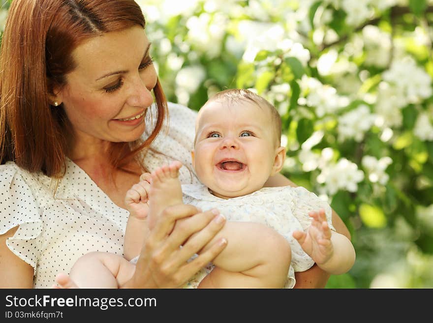 Mother and daughter close up portrait on flower background