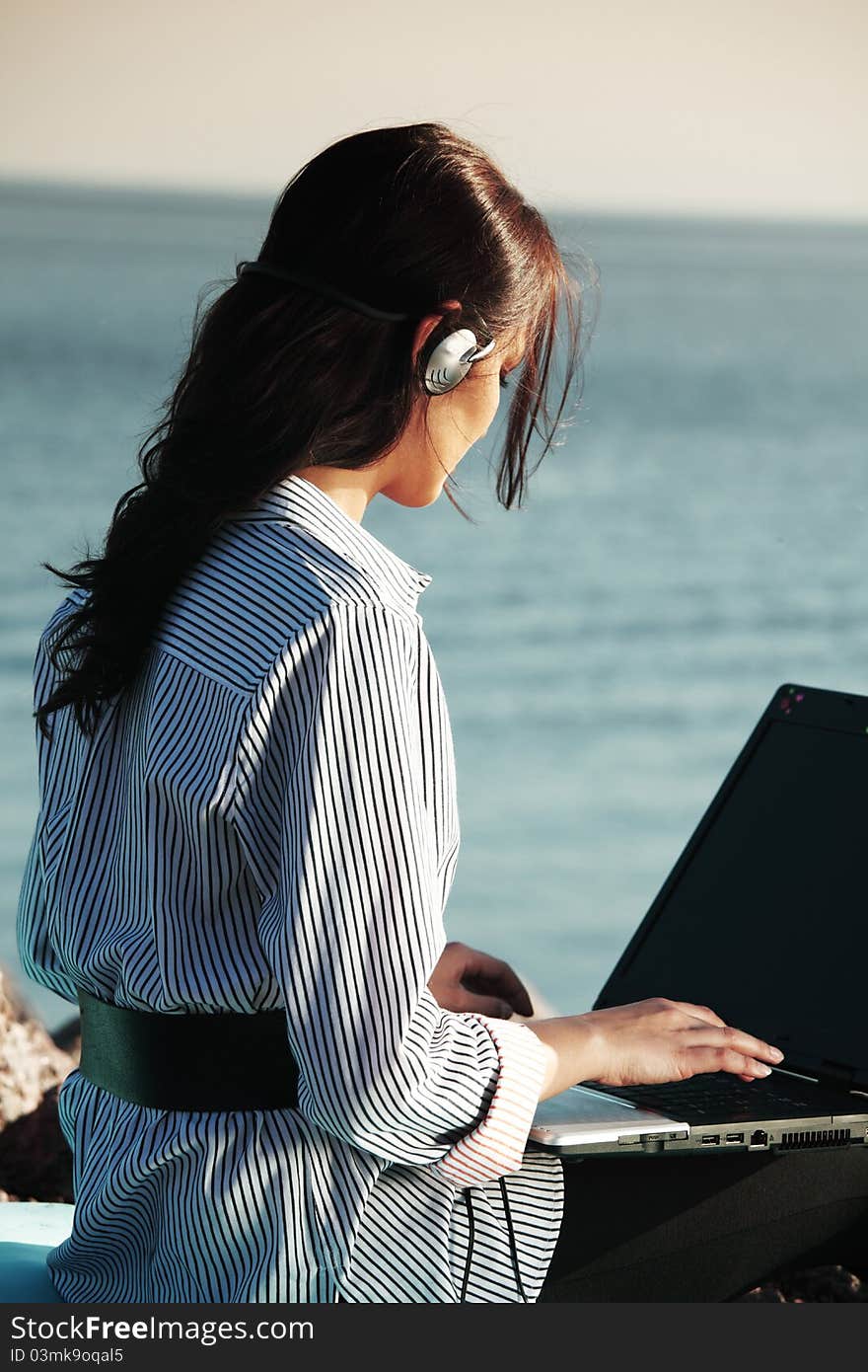 Woman work on laptop sea on background. Woman work on laptop sea on background