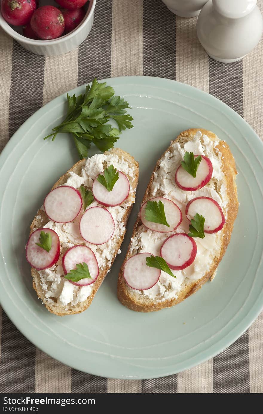 Sourdough with goat's cheese and radish on a plate. Sourdough with goat's cheese and radish on a plate