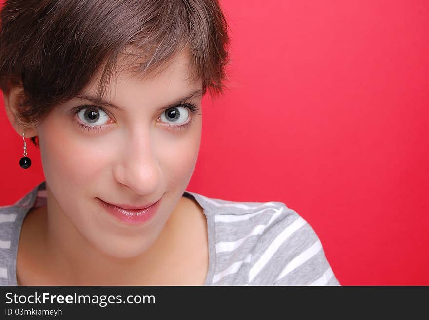 Portrait of a young woman on red