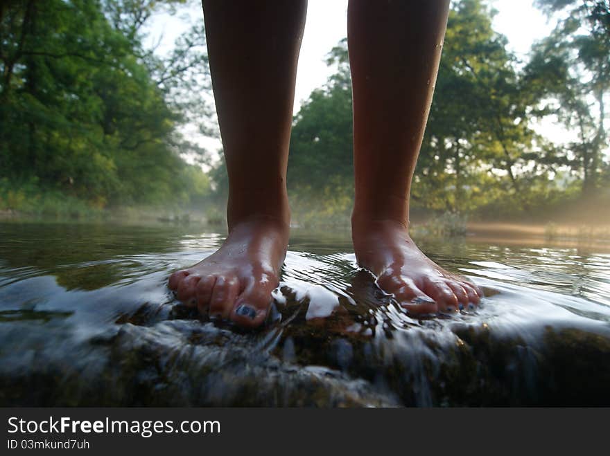 Feet standing on an overflowing road. Feet standing on an overflowing road