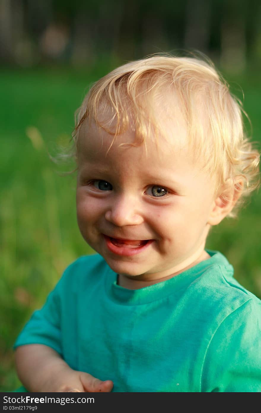 Happy baby smile in grass. Happy baby smile in grass