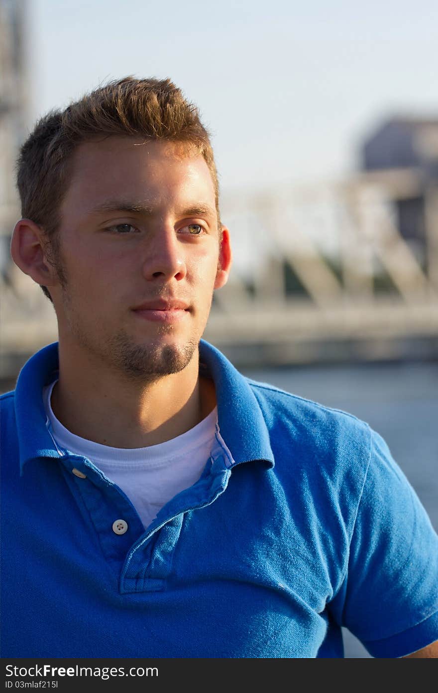 A young man portrait with bridge in background. A young man portrait with bridge in background