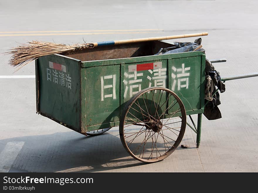 Chinese style cleaning cart with broom on road, the Chinese characters on cart means cleaning daily