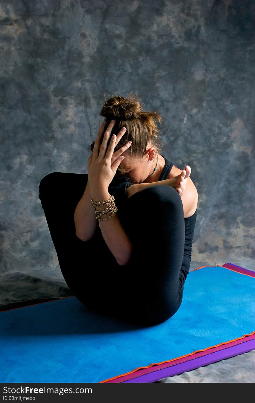 Woman doing yoga exercise Womb pose