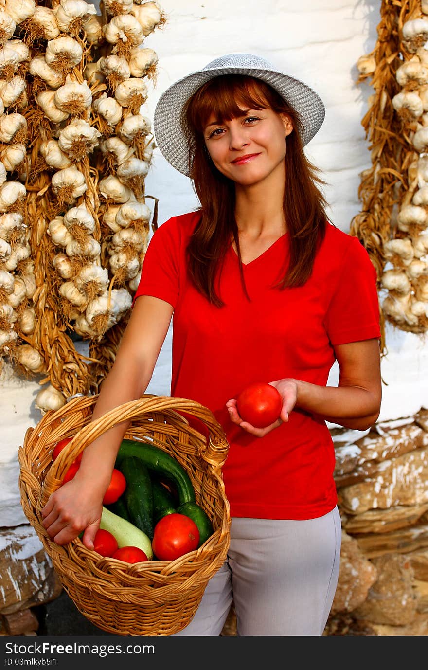 A woman holding basket with different vegetables. A woman holding basket with different vegetables