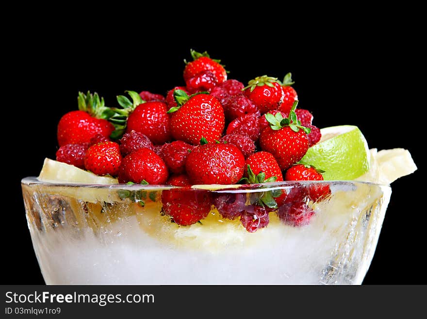 Different fruit in bowl made of ice