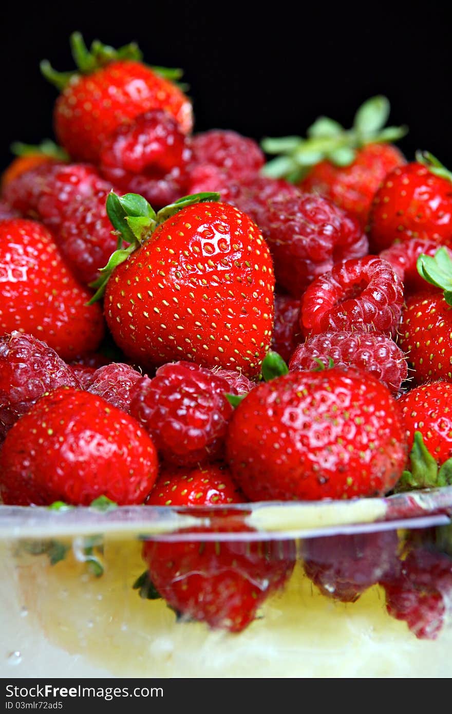 Different fruit in bowl made of ice