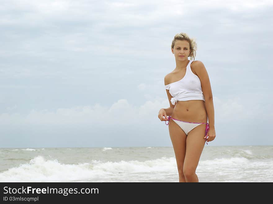 blond girl posing on a beach. blond girl posing on a beach