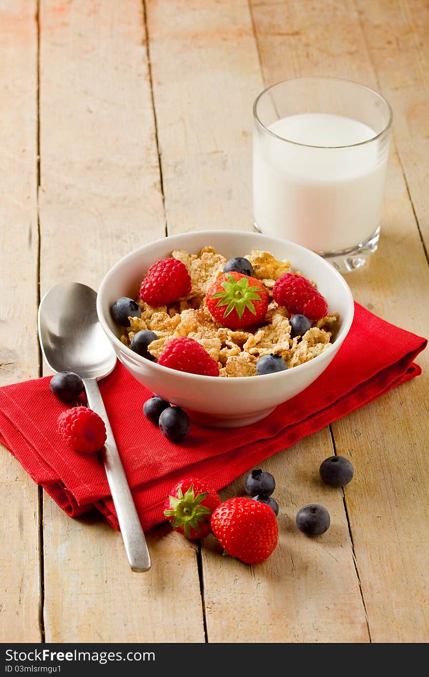 Photo of delicious breafast made of corn flakes with berries and fresh milk. Photo of delicious breafast made of corn flakes with berries and fresh milk