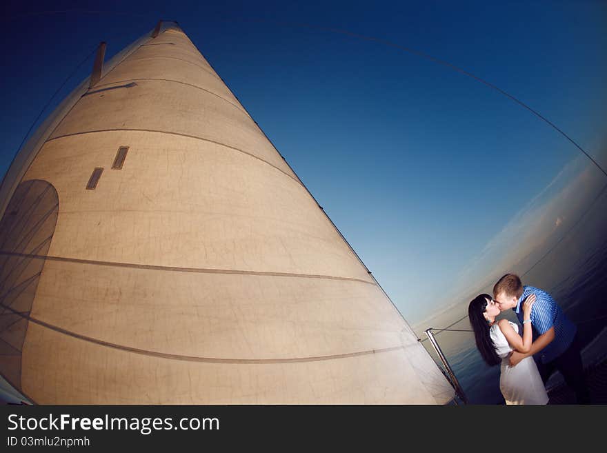 Man and girl under the sail. Man and girl under the sail