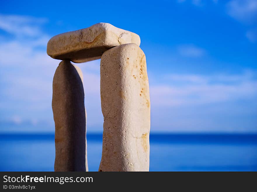 Balancing of three white pebbles on the sea coast. Balancing of three white pebbles on the sea coast