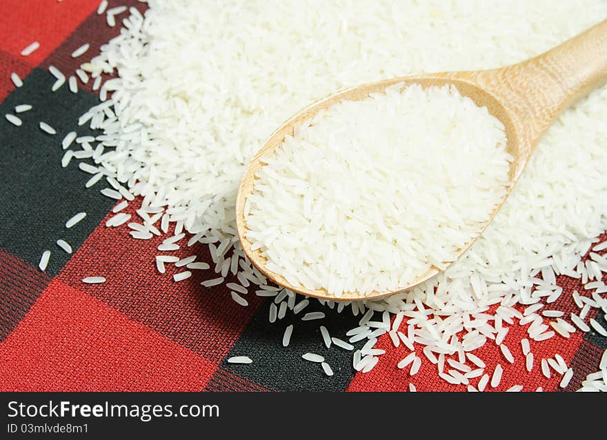 Rice grain and wooden spoon