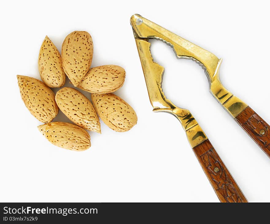 Almonds and antique nut cracker. Almonds and antique nut cracker