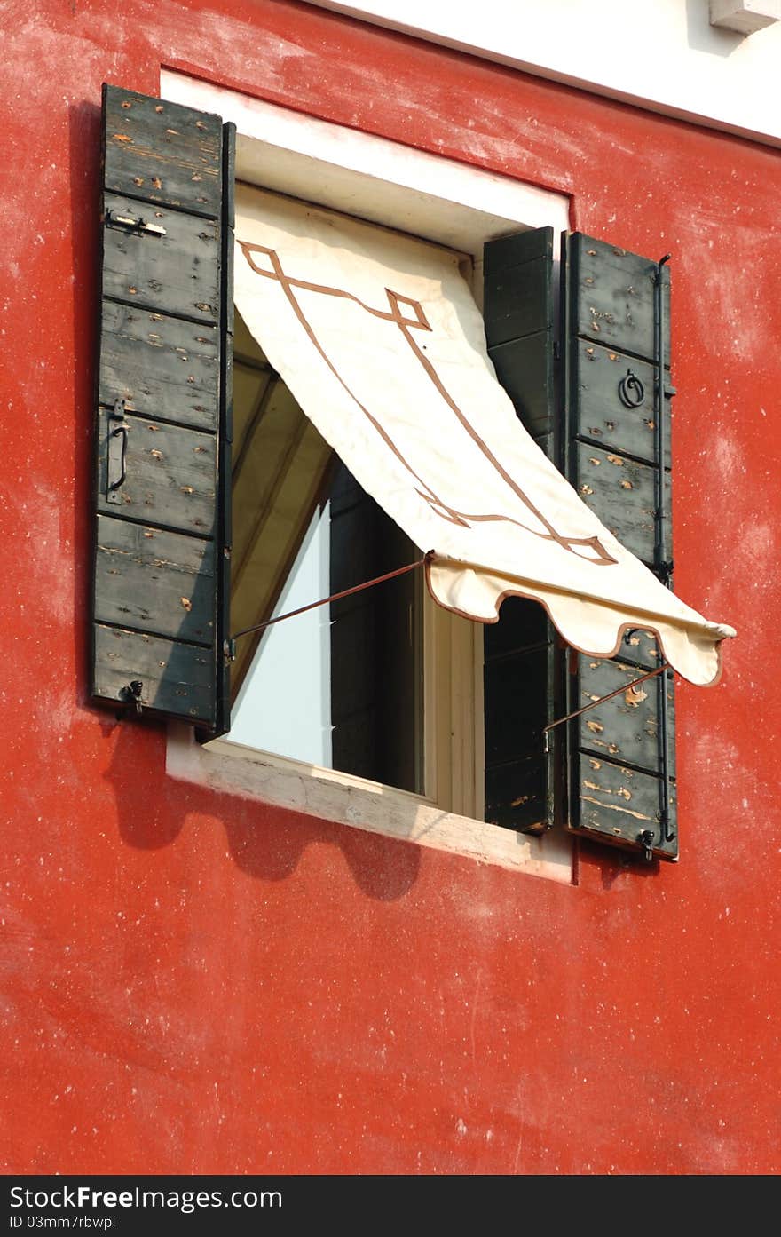 Old window on red wall,Venice, Italy