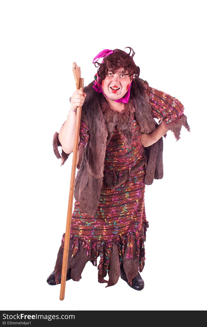 A guy dressed as a witch with a stick. White background. Studio photography. A guy dressed as a witch with a stick. White background. Studio photography.