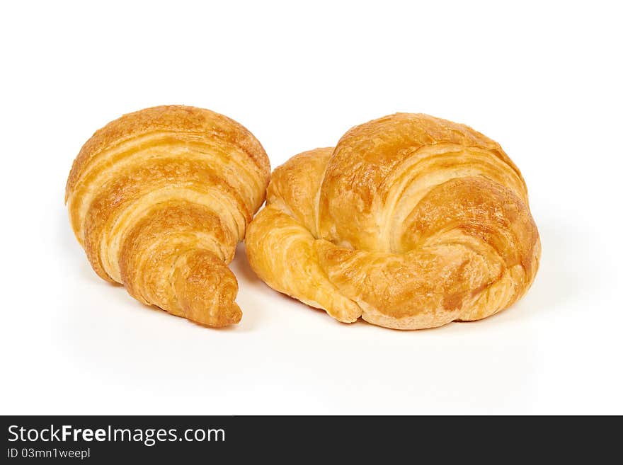 Two fresh and tasty croissants isolated on white. Two fresh and tasty croissants isolated on white