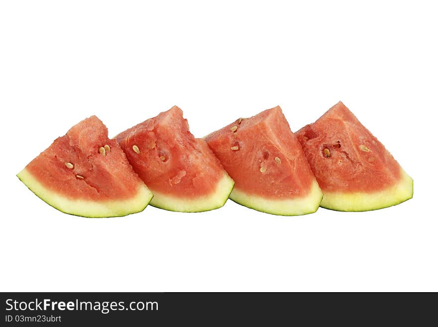 Four organic watermelon triangle slices upright side by side on white background. Four organic watermelon triangle slices upright side by side on white background.