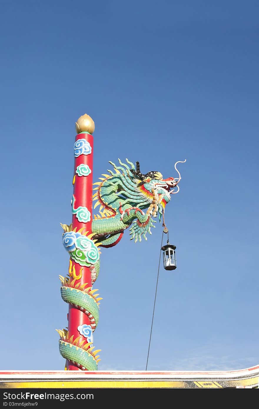 Red dragon climbing the pole. Northern Chinese temple, blue sky. Red dragon climbing the pole. Northern Chinese temple, blue sky.