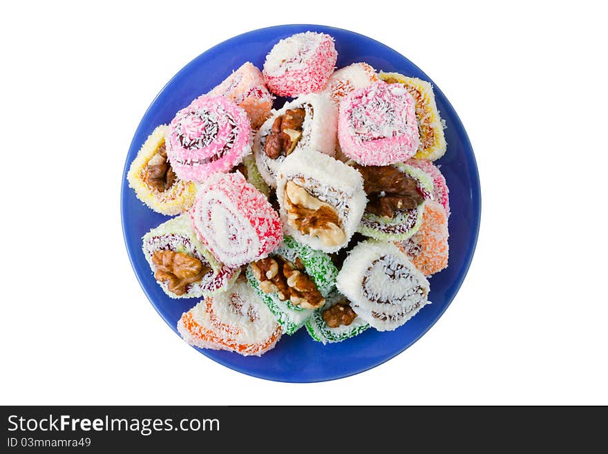 Sweets on blue dish, isolated on white. Sweets on blue dish, isolated on white