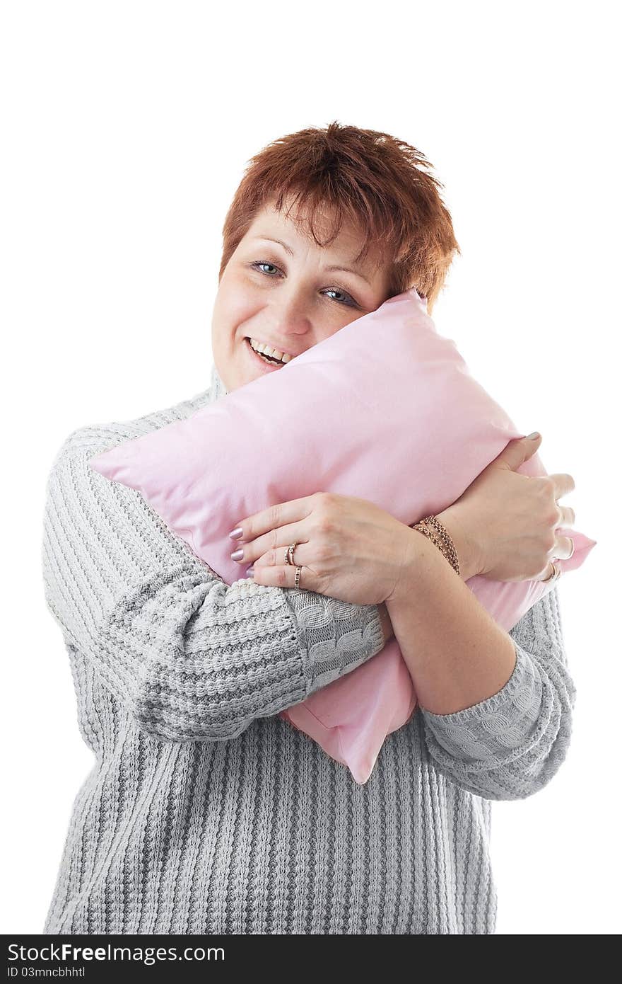 Happy woman hugs pink pillow isolated on white