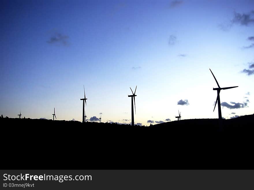 Wind farms, at sunset. Perpignan, Languedoc roussillon, Pyrenees Orientales, France. Bluesky with massive shadows.