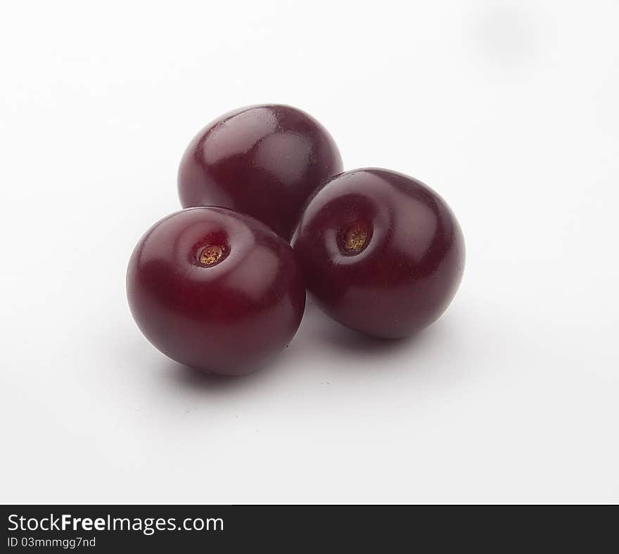 Some red cherries in the white background