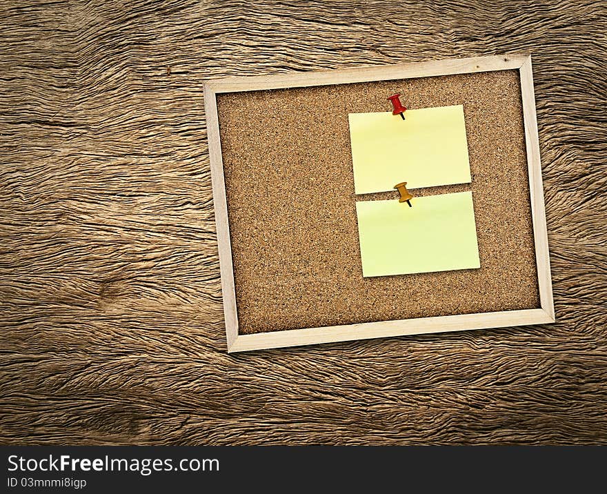 Note pad with bulletin board on wooden texture. Note pad with bulletin board on wooden texture