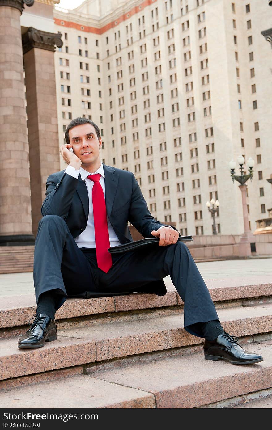 Young businessman calls on mobile in downtown. Young businessman calls on mobile in downtown