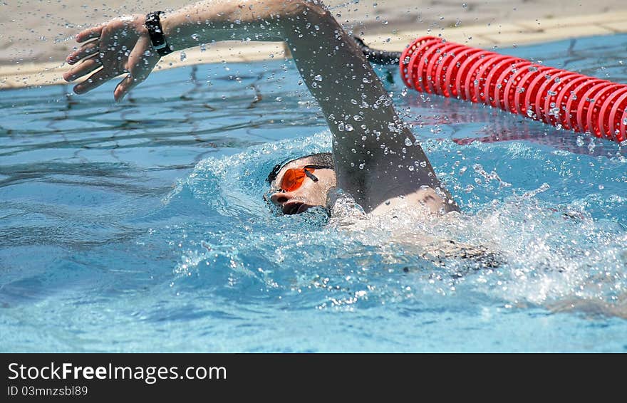 Professional Freestyle Swimmer in the outdoor pool. Professional Freestyle Swimmer in the outdoor pool