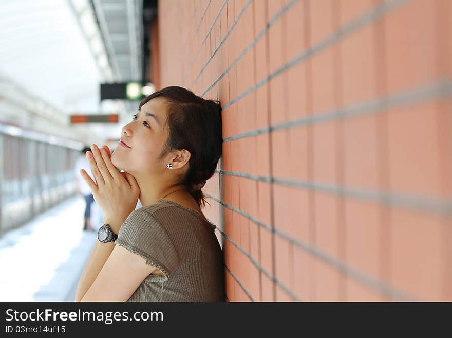 Asian Woman Waiting For Train With Smile