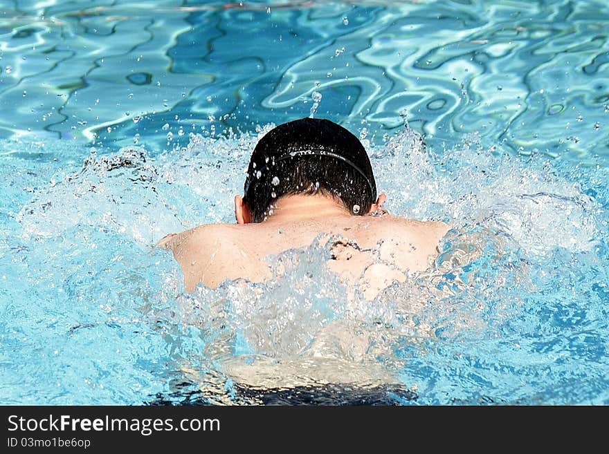 Professional Breaststroke swimmer in the outdoor pool. Professional Breaststroke swimmer in the outdoor pool