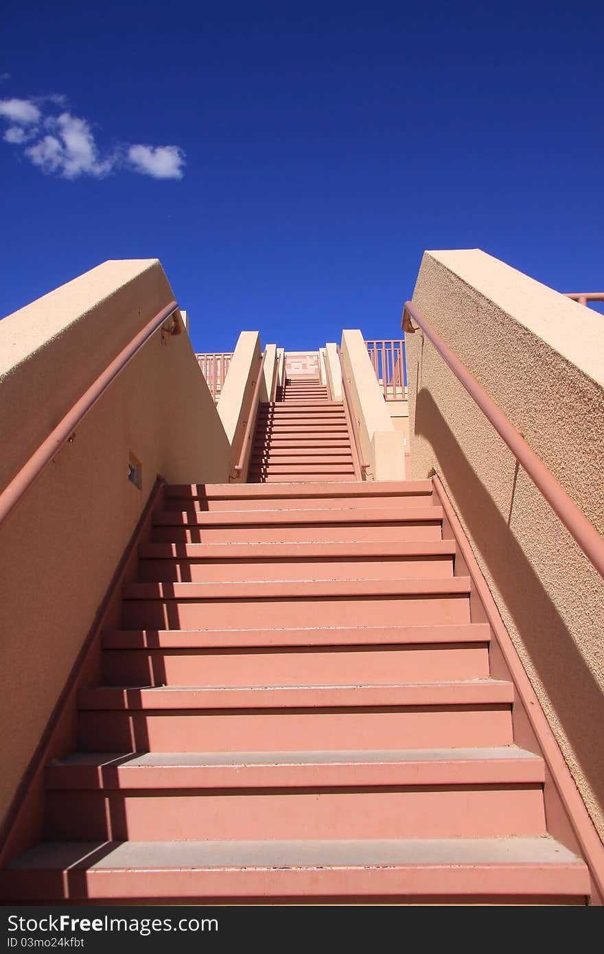 Stair case with red steps against blue sky. Stair case with red steps against blue sky