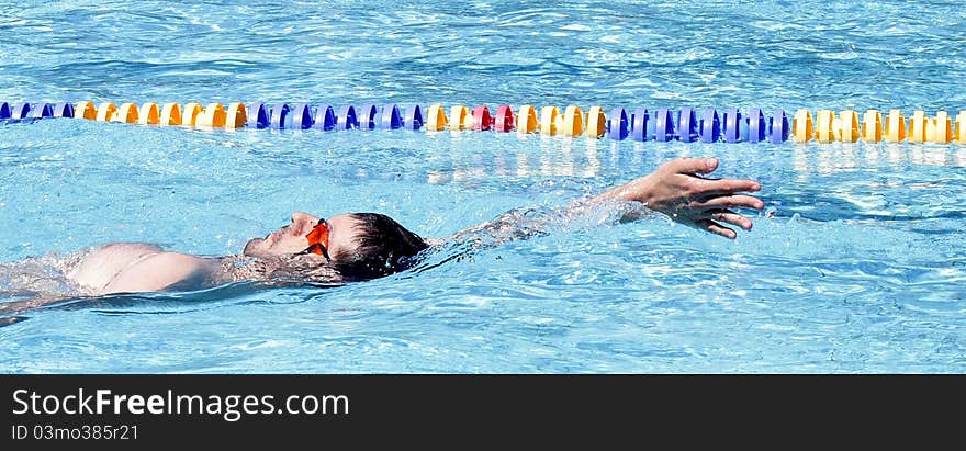 Backstroke swimming professional in the outdoor pool. Backstroke swimming professional in the outdoor pool