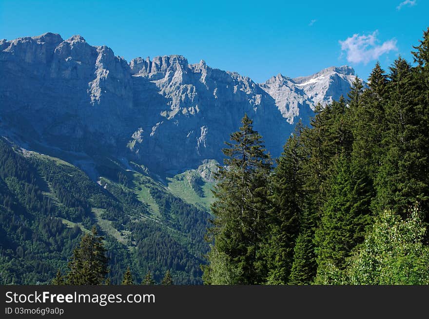 View on rocky mountains and evergreen forest in Swiss Alps. View on rocky mountains and evergreen forest in Swiss Alps