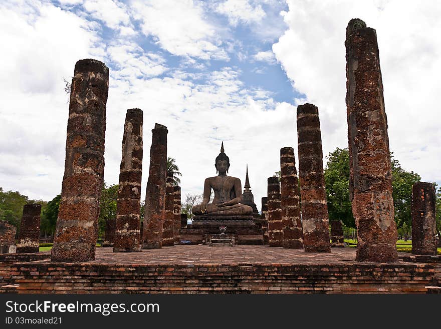 Buddha Statue Among Pillars