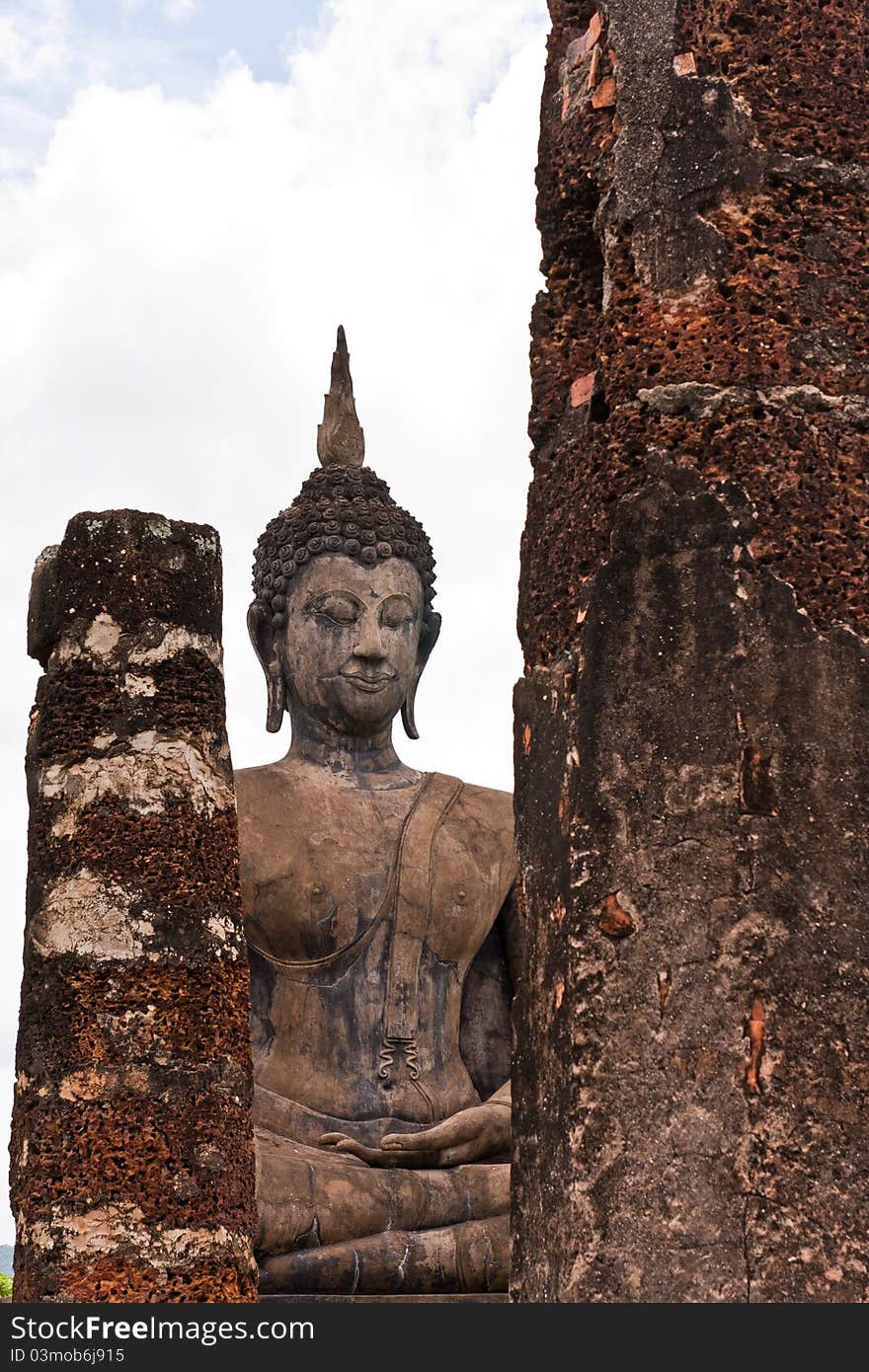 Buddha Statue Behind  Pillars