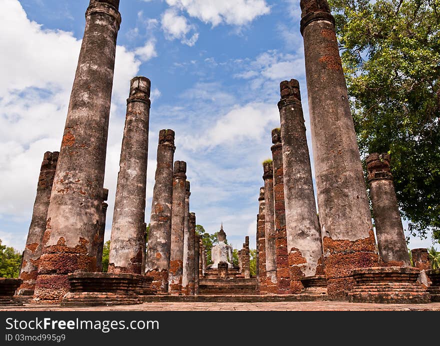 Buddha Statue Among Pillars From Back Worm