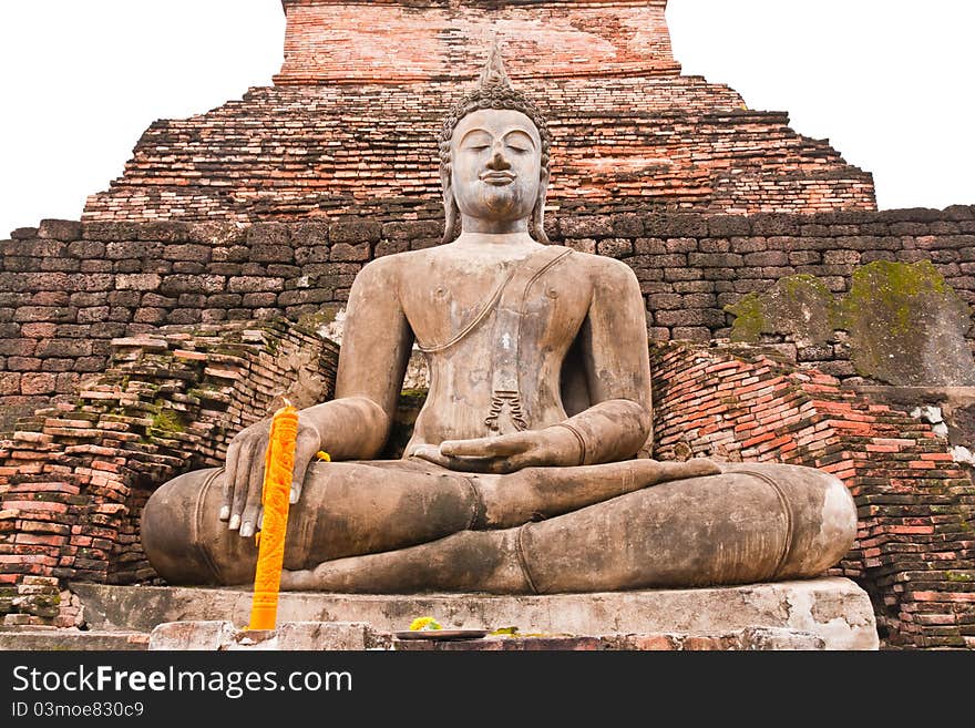 Ruin Buddha statue in front of ruin pagoda in Sukhothai historic park. Ruin Buddha statue in front of ruin pagoda in Sukhothai historic park