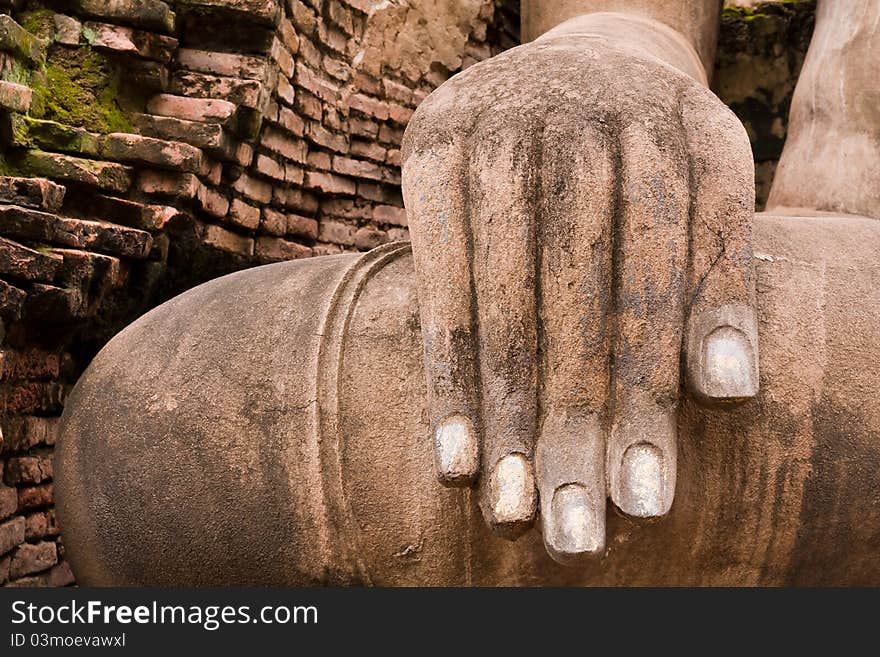 Hand of Buddha statue on right