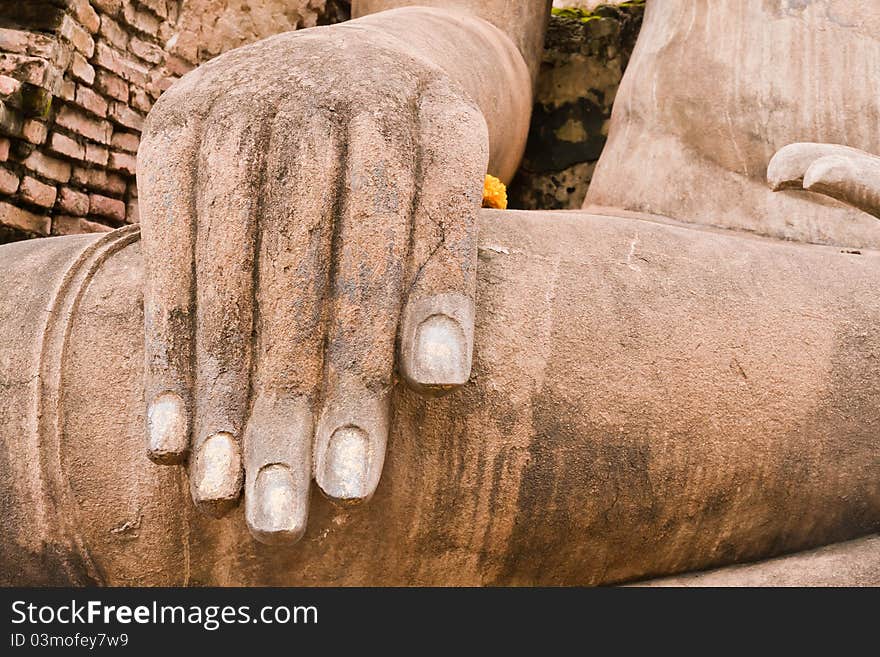 Hand of ruin Buddha statue in Sukhothai historic park on left. Hand of ruin Buddha statue in Sukhothai historic park on left