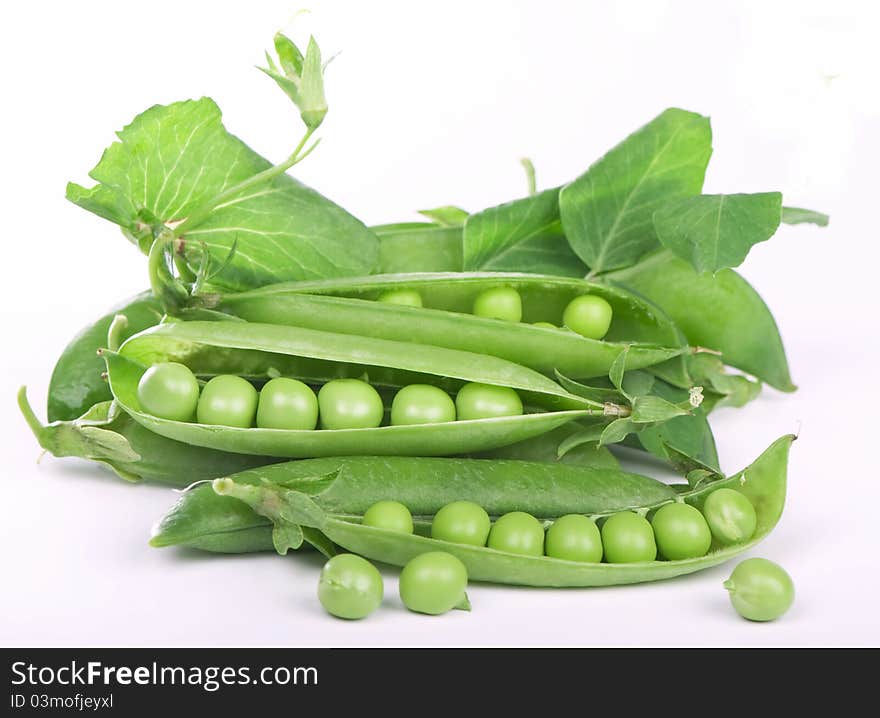 Green peas in pod close-up on white background