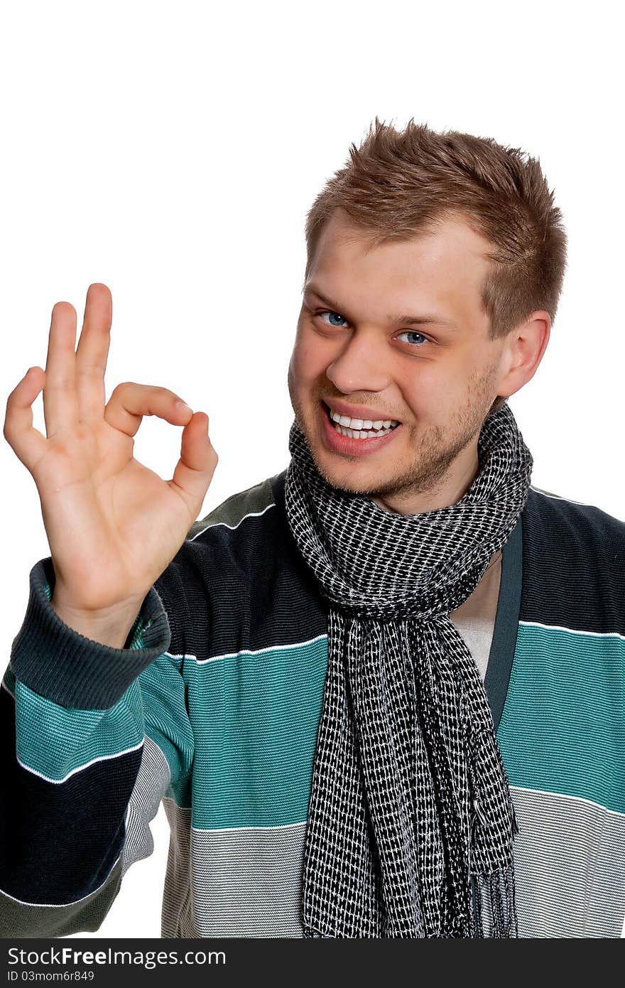 A young man in a gray-blue pullover intently thinking poses in the studio on a white background. A young man in a gray-blue pullover intently thinking poses in the studio on a white background