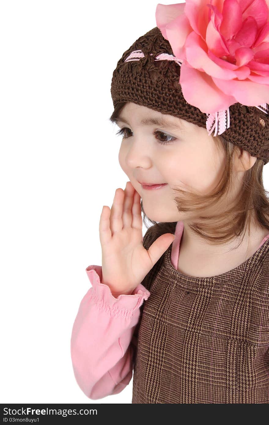 Cute brunette toddler earing a lollipop against white background. Cute brunette toddler earing a lollipop against white background