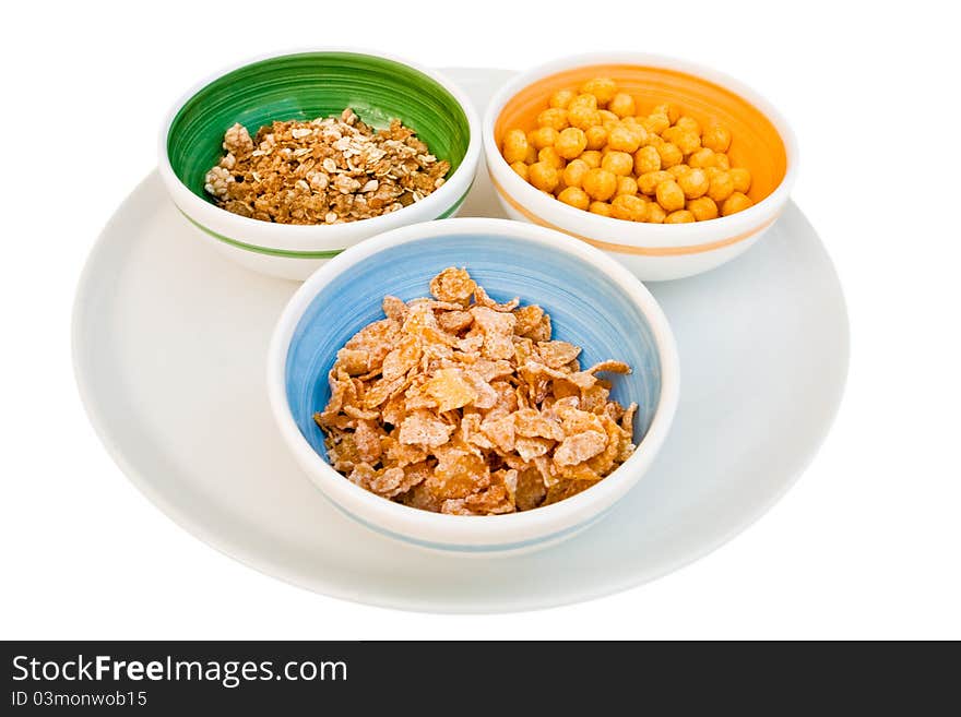 Plate with three kind of cereals for breakfast isolated on white