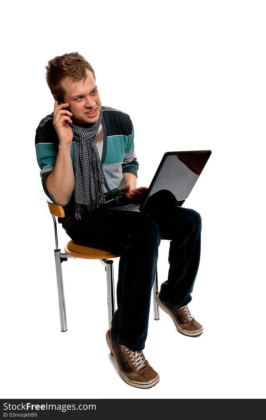 Young man with laptop and mobile phone